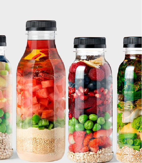 Four transparent bottles brimming with a variety of foods, such as quinoa, chia seeds, and dried fruits, representing the products of Southlander, Wholesale Flowers Near Me and Bulk Organic Food Produce Distributors.